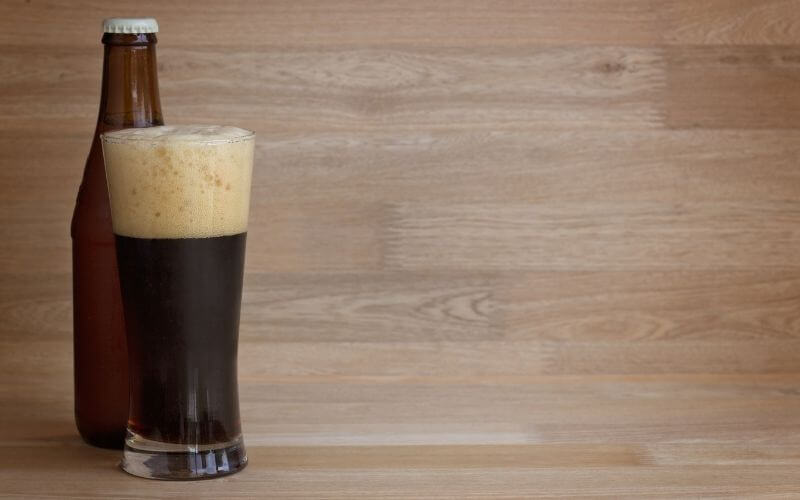 Stout beer in glass and bottle