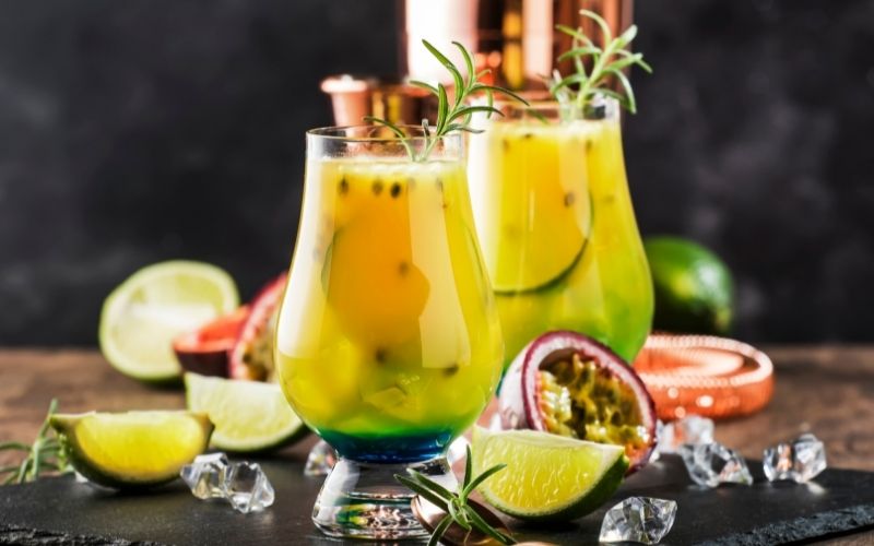 Summer Passion Fruit cocktail with limes and ice