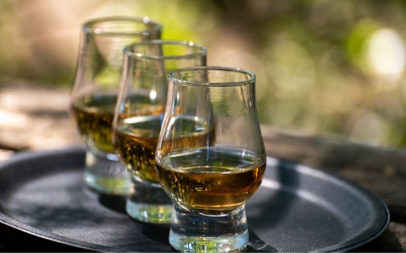 Tasting of different Scotch whiskies on an outdoor terrace