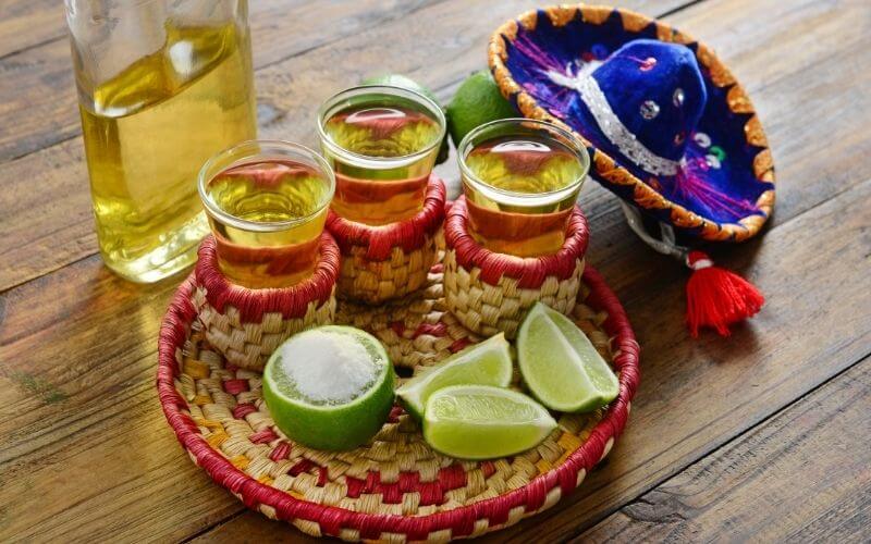 Tequila shots with limes and a small sombrero