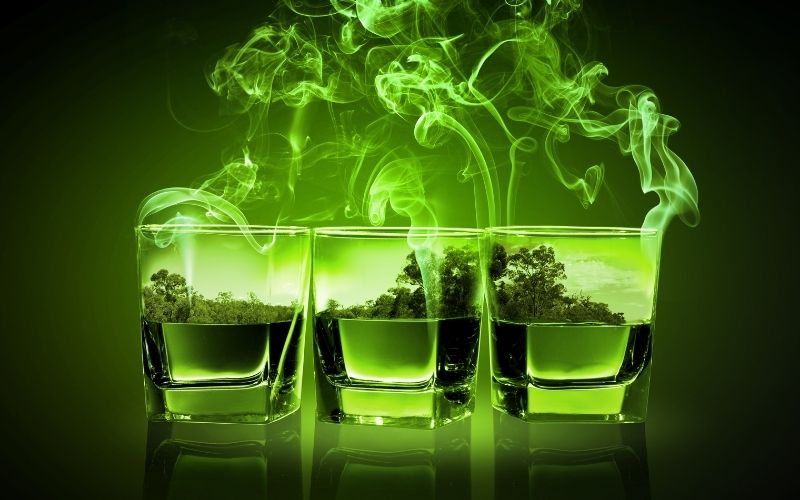 Three glasses of green absinthe