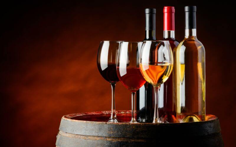 Three types of wine on a barrel