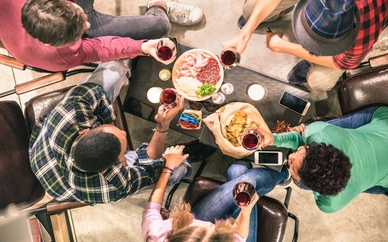 Top view of friends drinking and eating