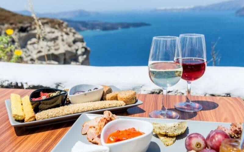 Two glasses of red and white wine with different types of food