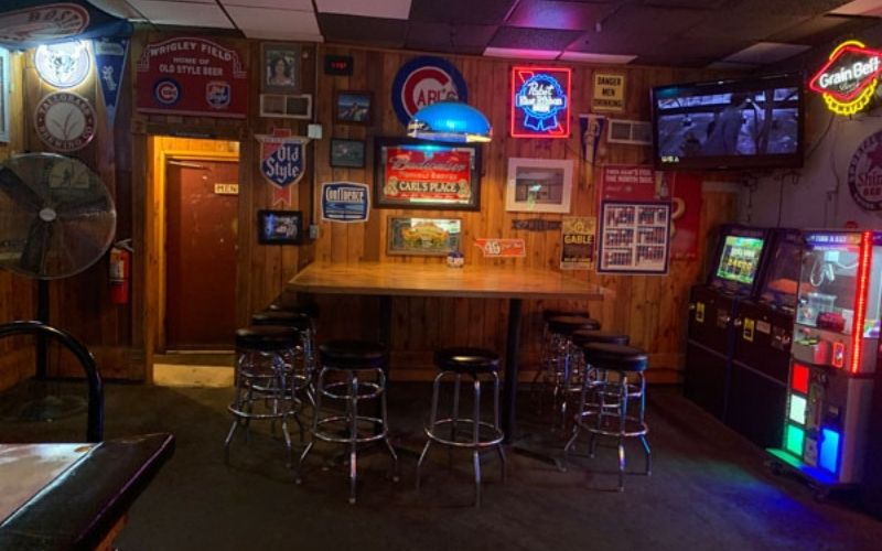 Stools, tables, and gaming machines inside dive bar