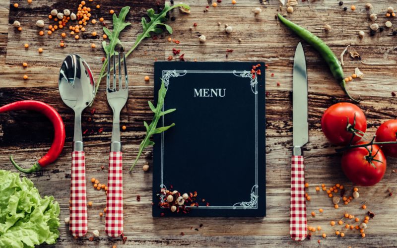 Black menu on a wooden table