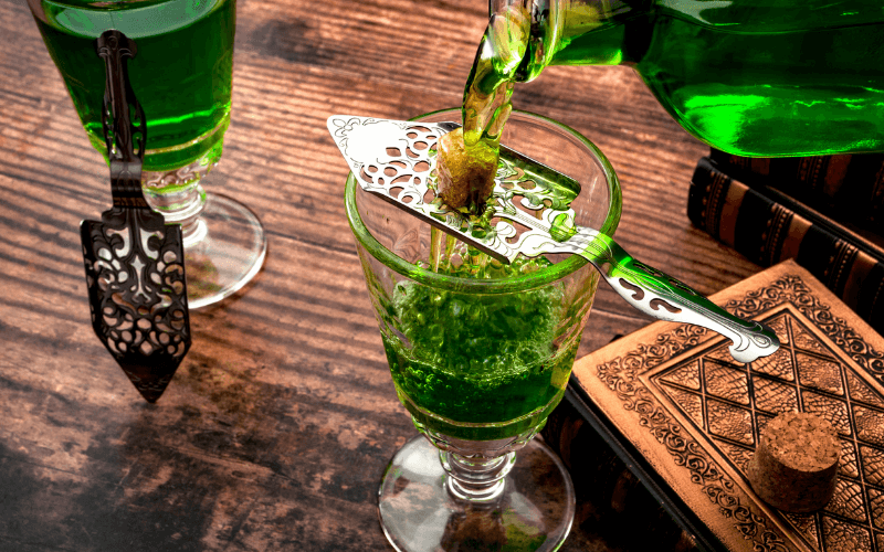 Pouring absinthe over the sugar