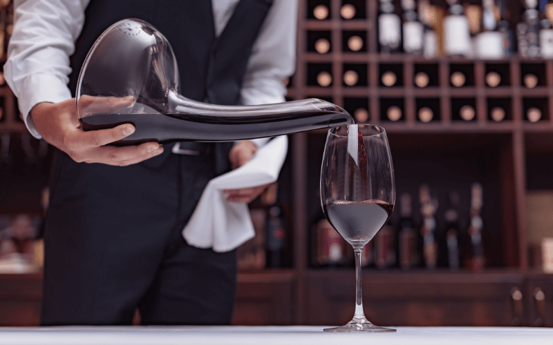 Sommelier pouring wine from a decanter