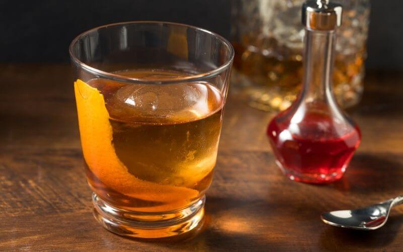 Vieux Carre Cocktail beside a spoon and bottle