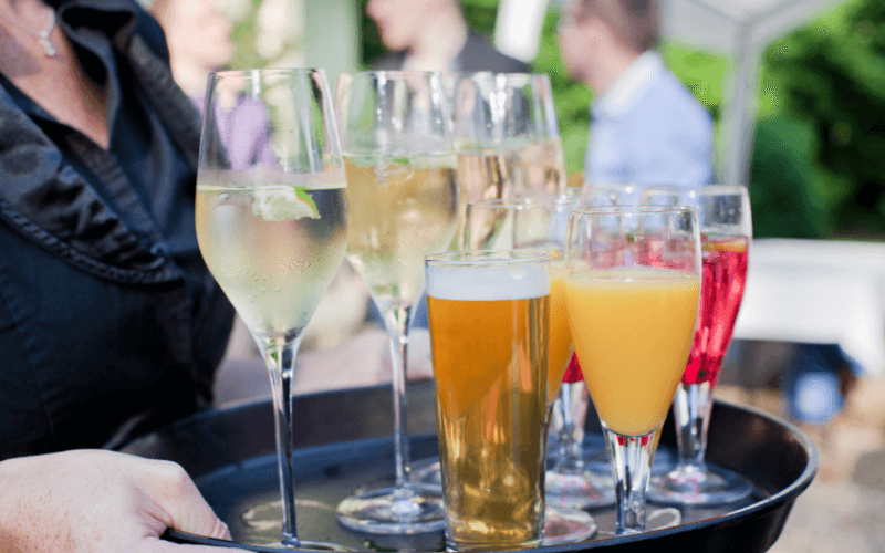 Waiter with a tray of champagne, beer, and other drinks