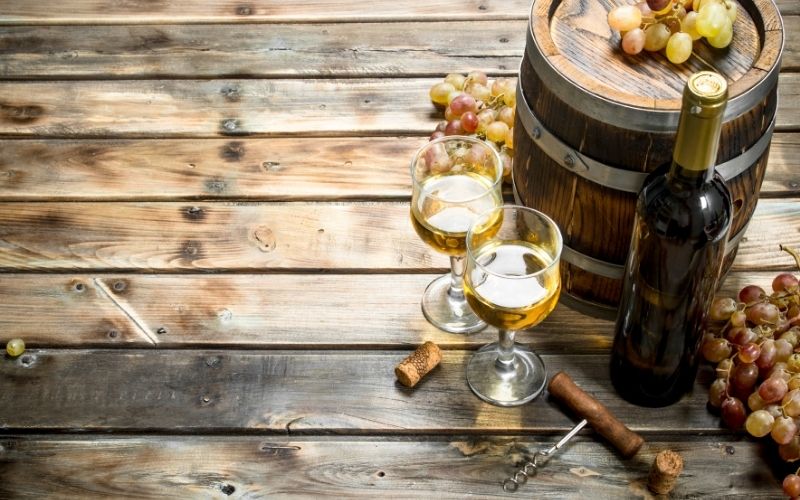 Wine background. White wine in an old barrel