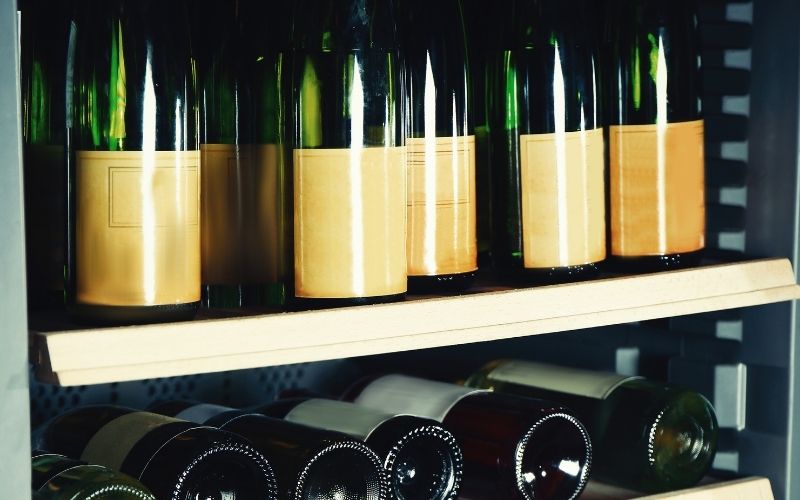 Wine bottles in a wine fridge 