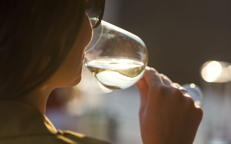 Woman drinking non-alcoholic white wine