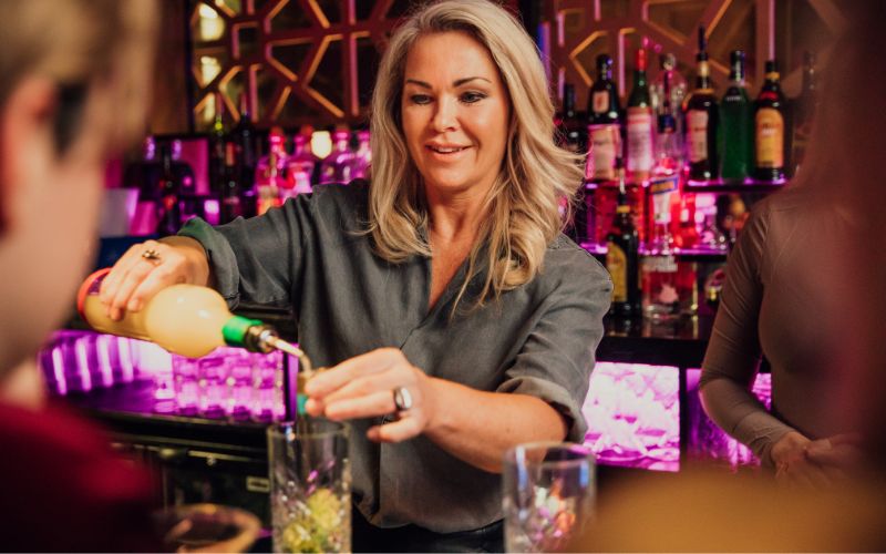 Woman making drinks at the bar