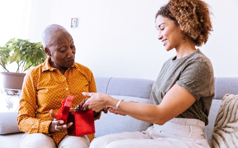 Woman presenting a gift to her grandma