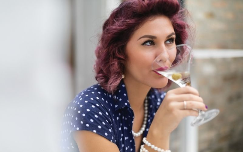 Woman sipping on a martini