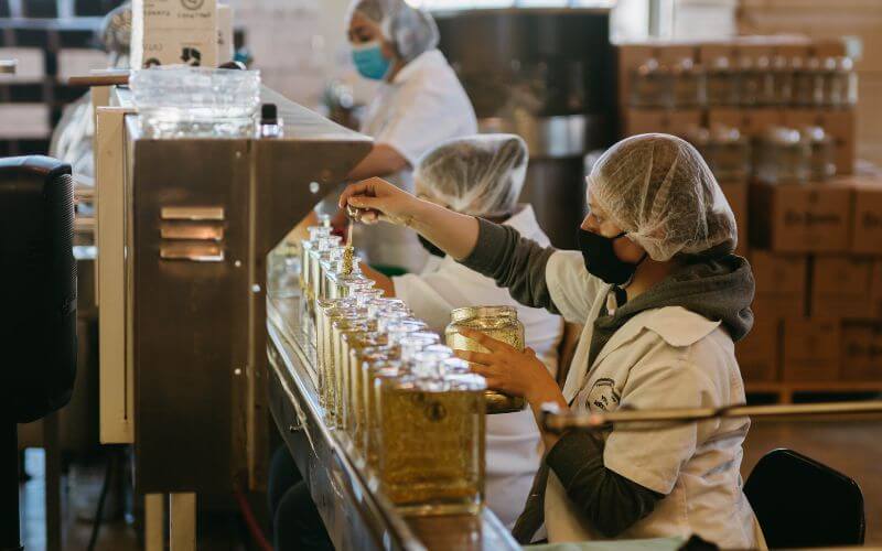 Workers bottling tequila in a distillery 