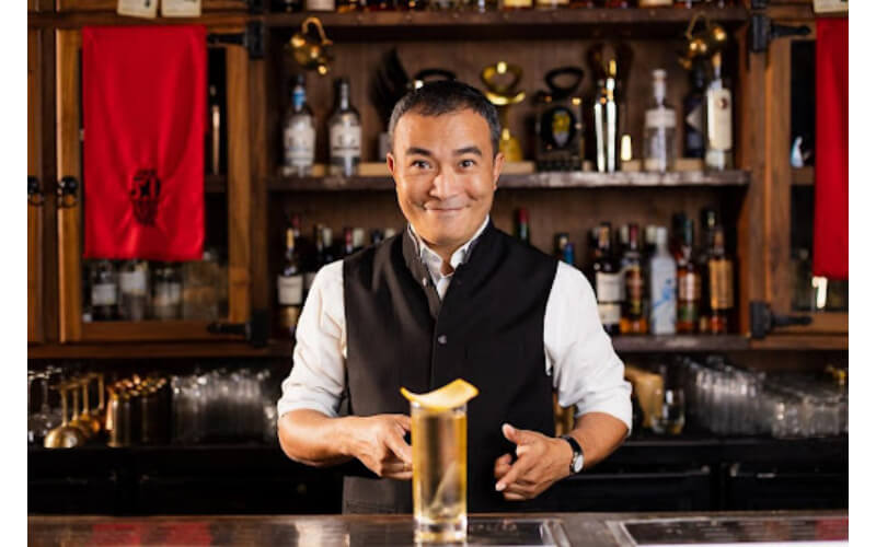 Yangdup Lama behind a bar