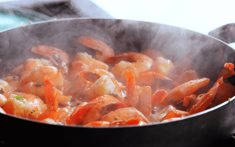 A pan full of shrimp cooked with tequila