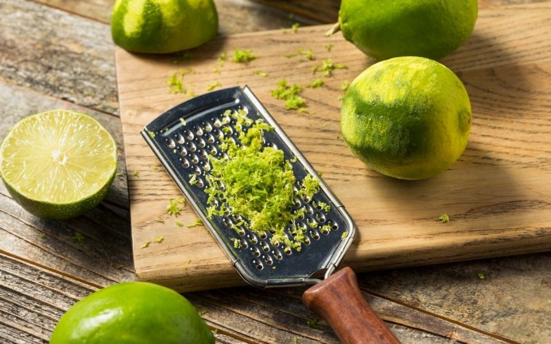 Zesting limes on a cutting board