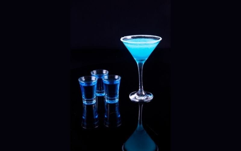 a glass and three shots of Aqua Pearl