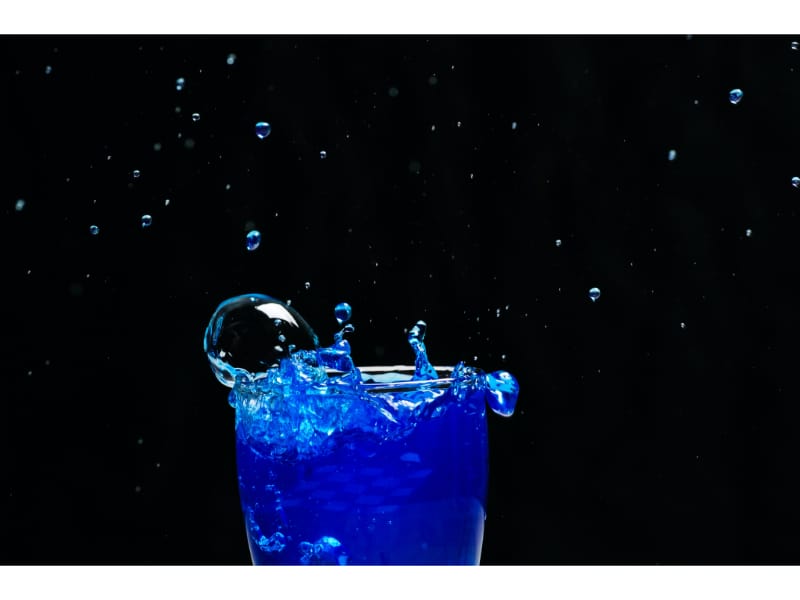A glass of blue liquid