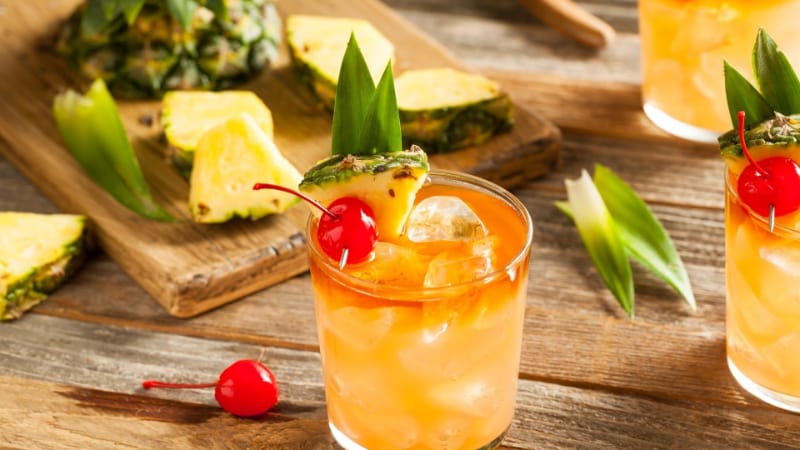 A glass of Mai Tai with fresh cherry and pineapple