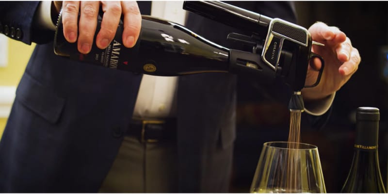 A man pouring a wine using Coravin wine Aerator