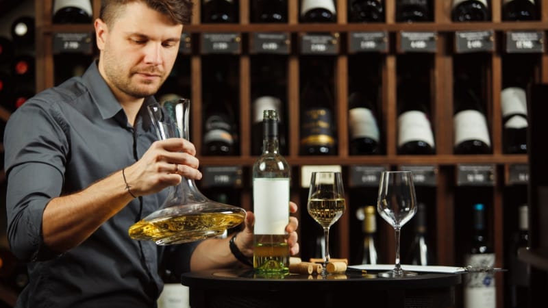 A man using a wine decanter