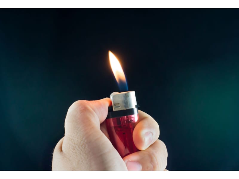 A person holding a lighter