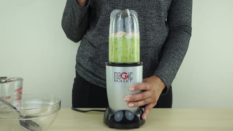 A person using a single-served blender