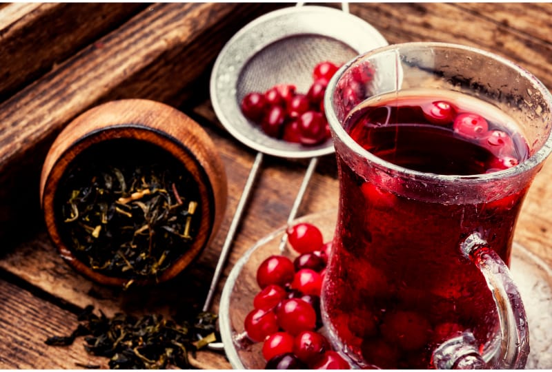 A Pitcher of Berry Tea on Wooden Table