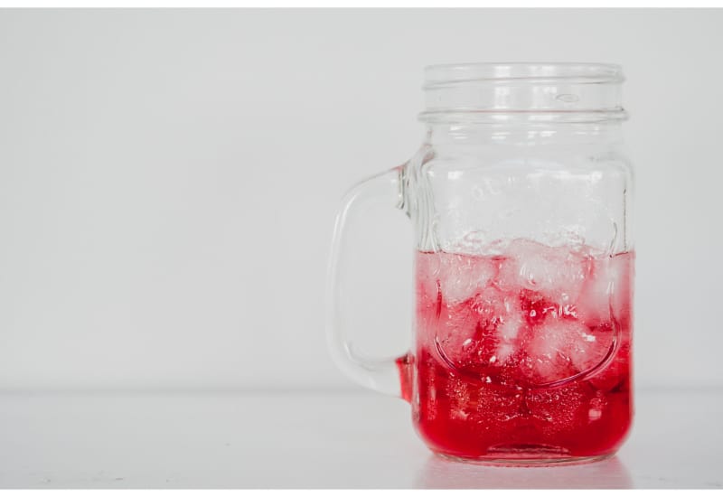 A strawberry drink in a mason jar