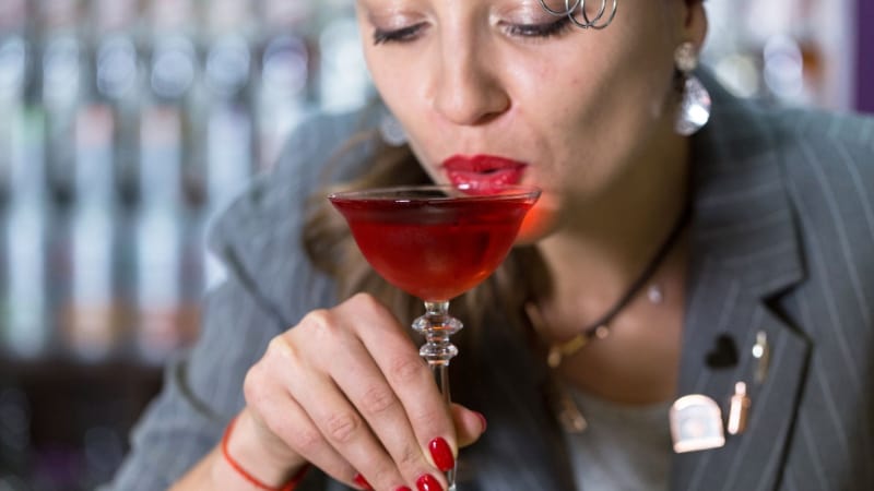 A woman sipping her cocktail