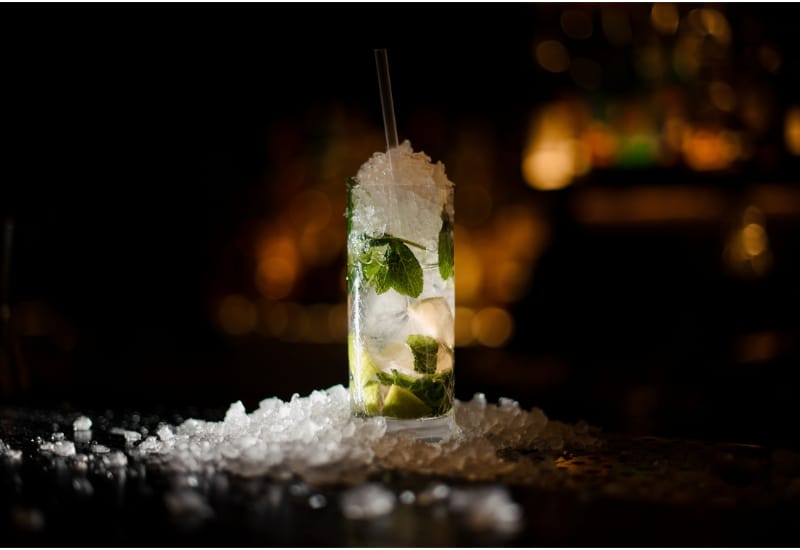 alcoholic cocktail mojito stands on a bar counter