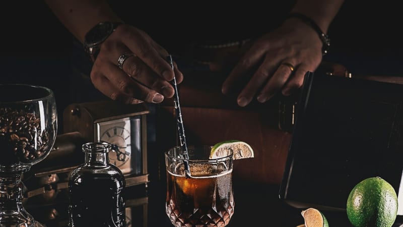 Black Magic cocktail being mixed with a bar spoon