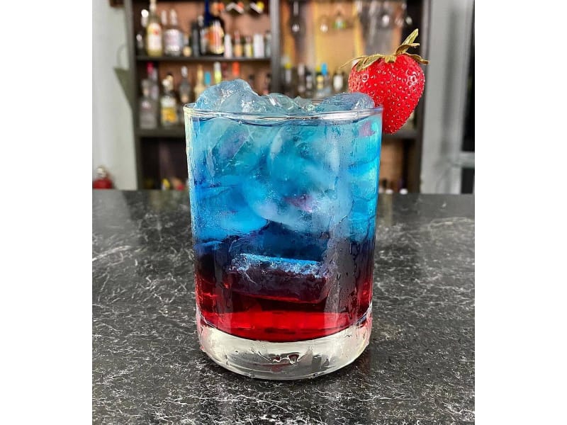 Bloodthirsty cocktail in a glass with a strawberry garnish