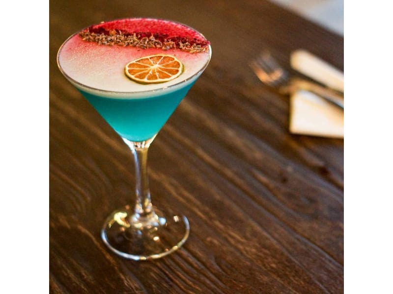 Blue Beauty cocktail in a martini glass