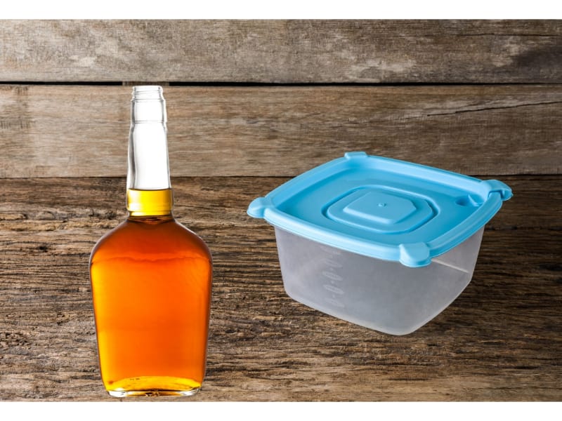 Bottle of bourbon and plastic container