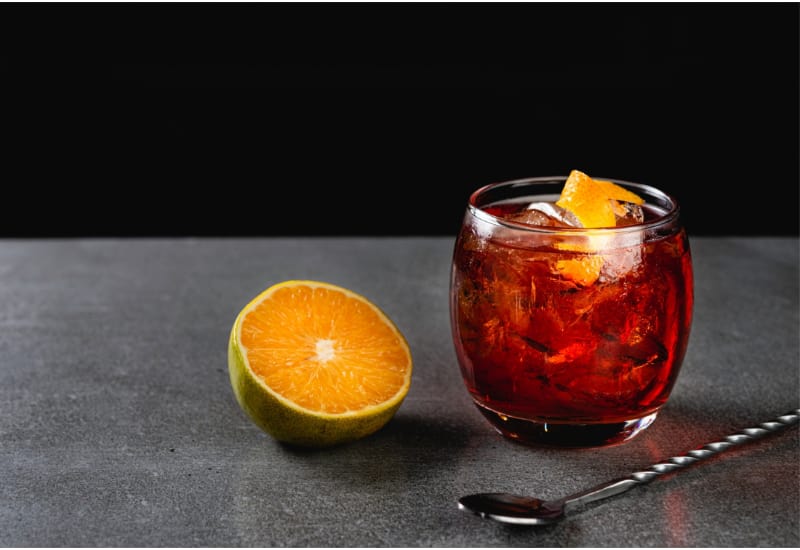 Boulevardier cocktail on stone background in gray color