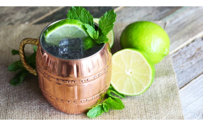 Classic Moscow mule served in a copper mug garnished with lime and mint leaves