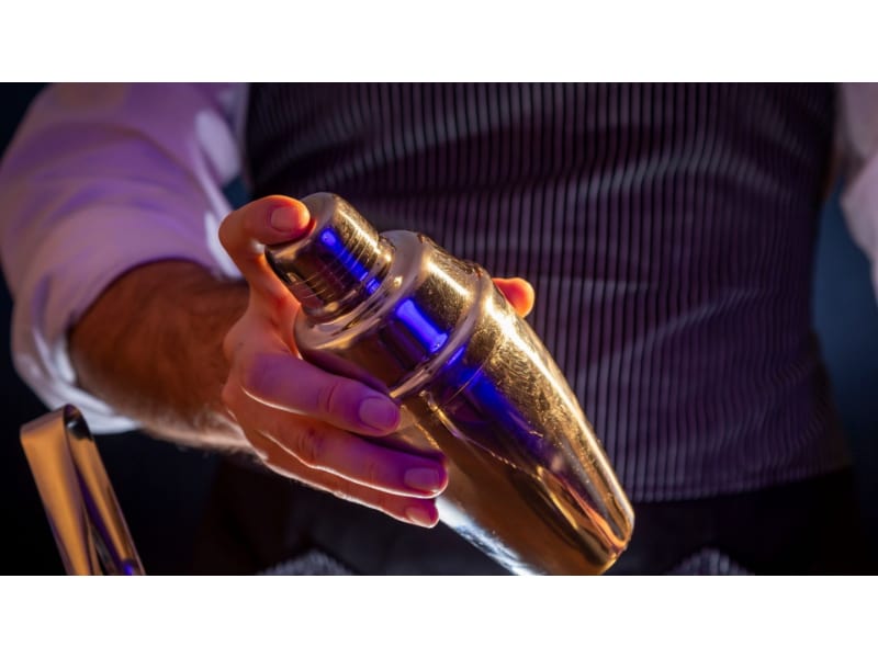 Cocktail shaker being used by a bartender