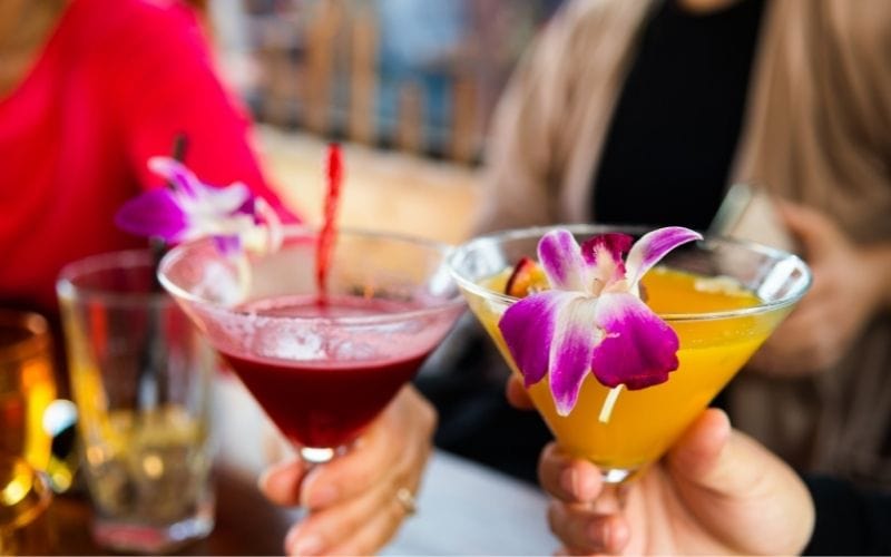 Cocktails in glasses with orchid flowers