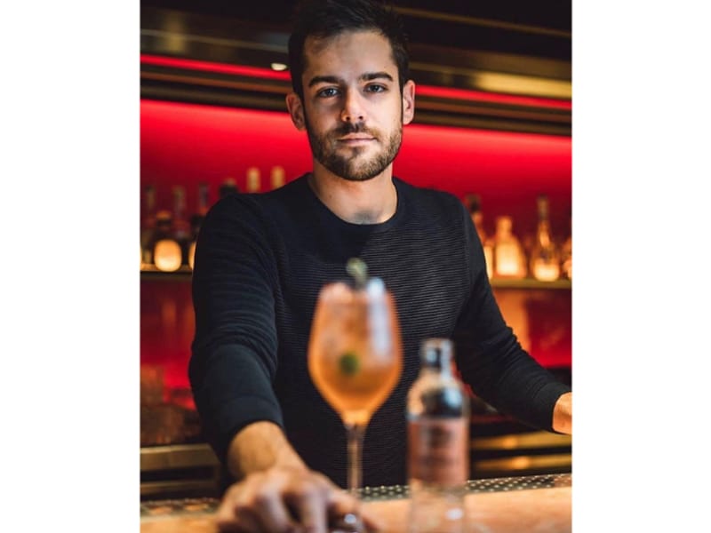 Federico Pasian holding a glass of cocktail