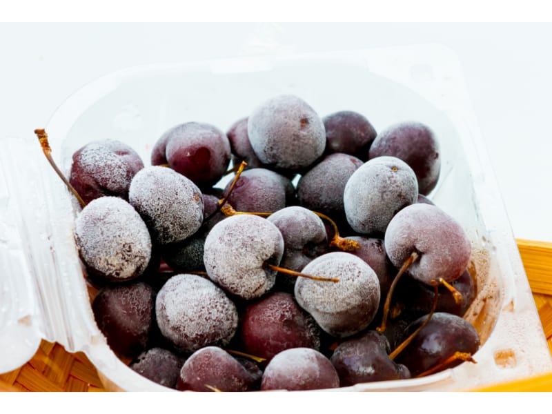 Frozen grapes in a plastic container