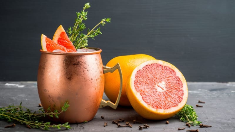 Greyhound cocktail with grapefruit, cinnamon, and star anise in a copper mug