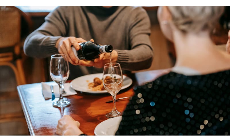 Guy pouring wine into a glass