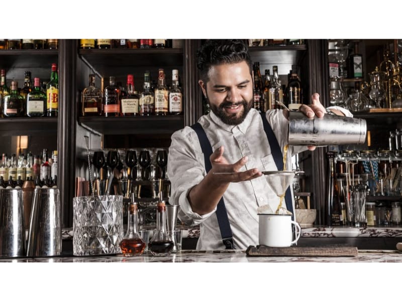 a bartender pouring drinks 