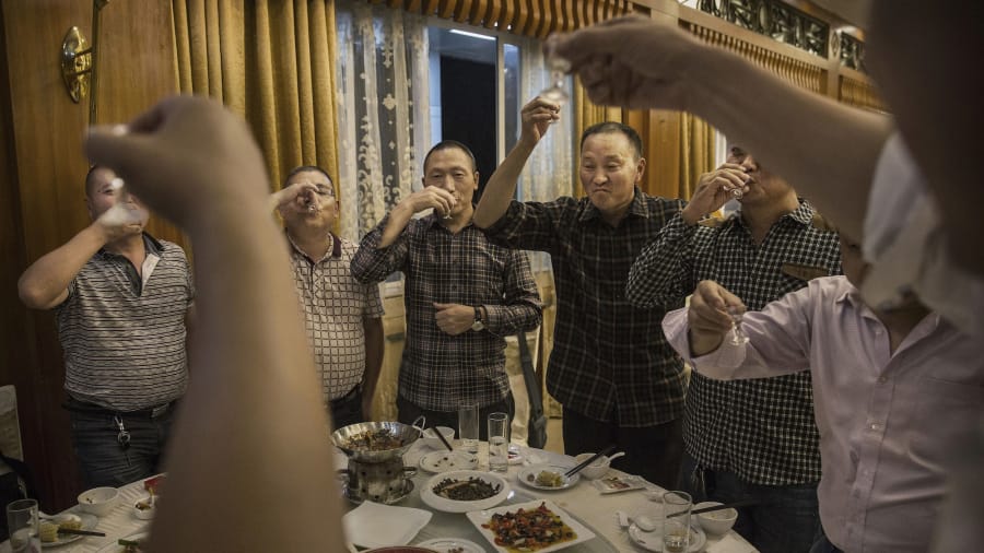 Chinese people toasting and drinking Baijiu - Image by CGTN