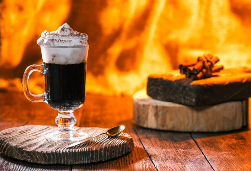 Irish coffee over fireplace light